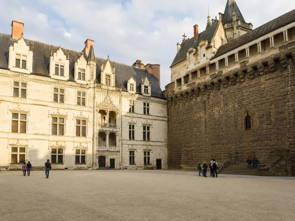 The white tufa ducal palace in the courtyard of the château